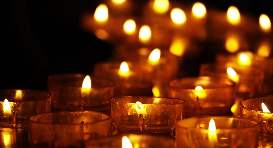 Candles glowing at night on a winter evening
